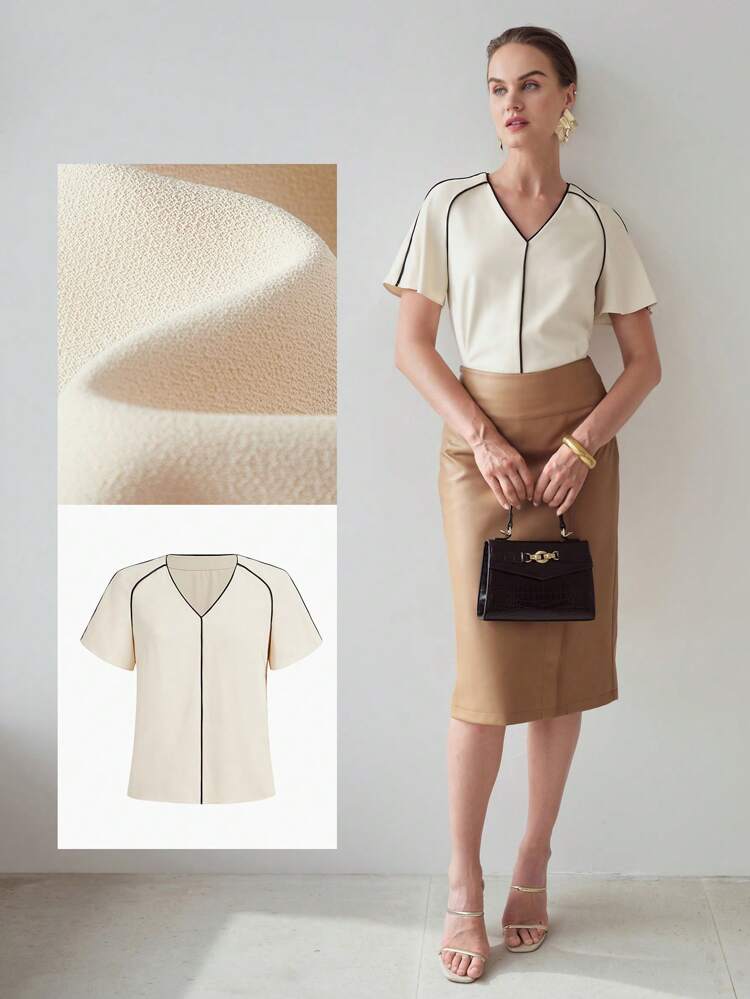BLUSA COM MANGAS FLUIDAS E DETALHE CONTRASTANTE NO ACABAMENTO
