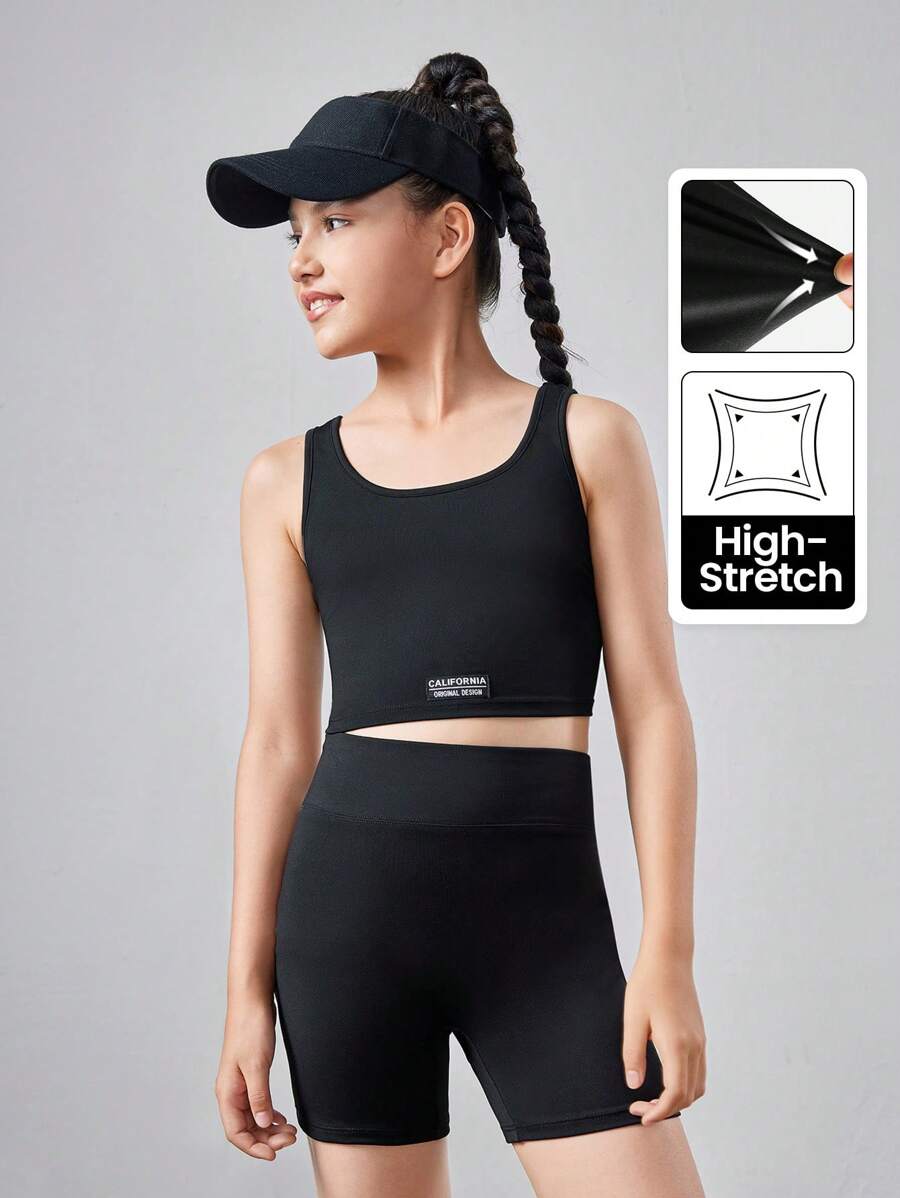SHEIN Conjunto de ropa deportiva para niña preadolescente con top corto de unicolor y shorts - Negro - Ver 1