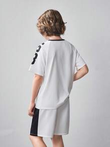 SHEIN Conjunto de 2 piezas para niño preadolescente con camiseta de manga corta con estampado gráfico holgada informal y pantalones cortos