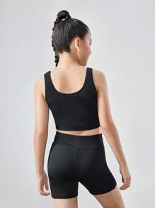 SHEIN Conjunto de ropa deportiva para niña preadolescente con top corto de unicolor y shorts - Negro - Ver 3