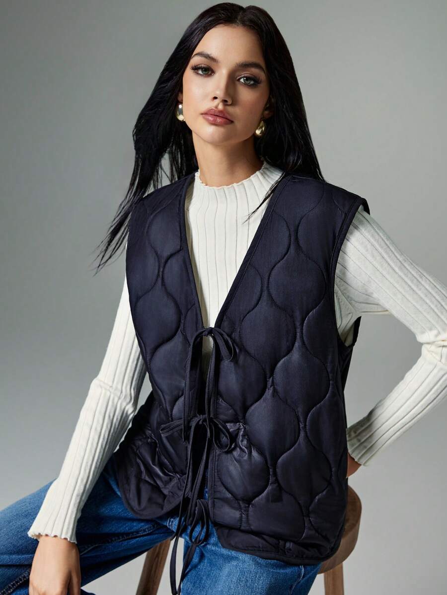 Poéselle Women's Fall/Winter Front Bow-Tie Wool-Lined Quilted Oversized Vest Jacket: A Two-Tone, Thick Sleeveless Outerwear Piece With A Center Bow Tie, Perfect For Outdoor Activities And Autumn Layering, Combining Warmth And Style In A Versatile Design. - Black - View 1