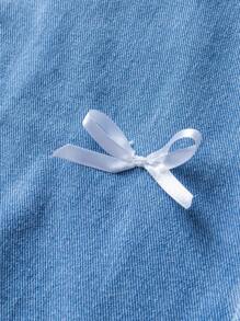 少女不对称设计牛仔裙，带破洞、蝴蝶结和水洗效果