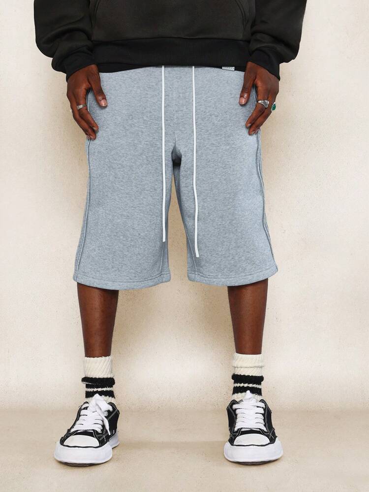 Jeans con pieghe e lacci