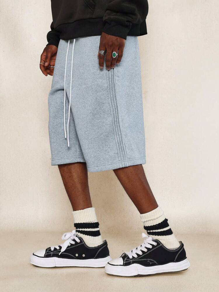 Jeans con pieghe e lacci