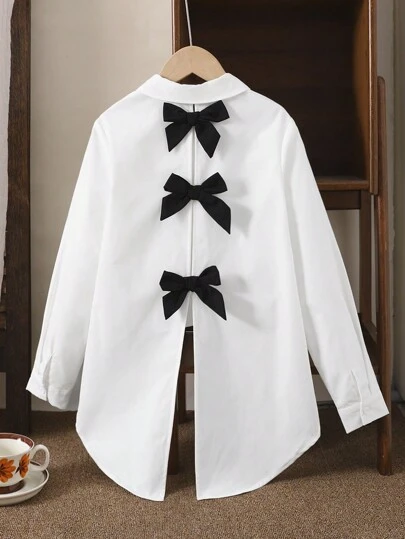 SHEIN LMoss Kids LMoss Tween Girl Back To School, Button Front White Woven Long Sleeve Blouse With Back Contrast Black Bow, Decoration And Curved Hemline