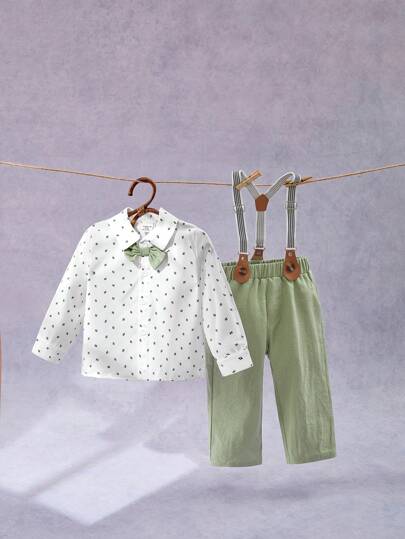 SHEIN 2 件装男婴绅士风格印花长袖衬衫（配领结和吊带裤）套装。柔软舒适的面料，优雅的印花图案，手工领结，可调节吊带设计，方便活动。适合生日、婚礼、派对场合。