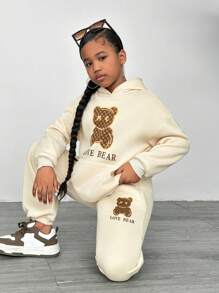 SHEIN Set de 2 piezas de sudadera y pantalón de chándal casual con estampado de osito para niñas preadolescentes - Beis - Ver 1