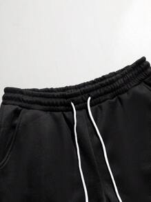 Manfinity LEGND Conjunto de sudadera con capucha y pantalón de chándal con estampado de calavera y letras para hombres de talla grande