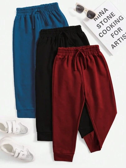 SHEIN Set de 3 pantalones jogger casuales de color liso y con nudo para niño