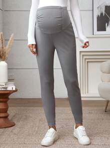 SHEIN Ciążowe legginsy plisowane w jednolitym kolorze z regulowanym stanem i swobodnym krojem
