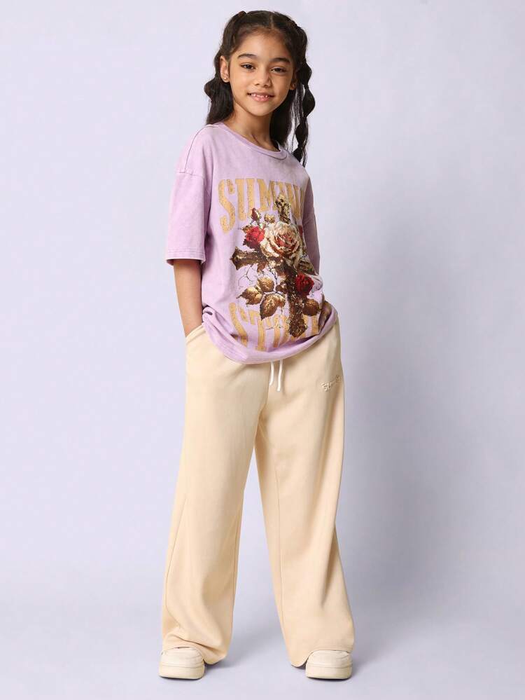 T-shirt oversize à imprimé floral croisé et typographie dorée