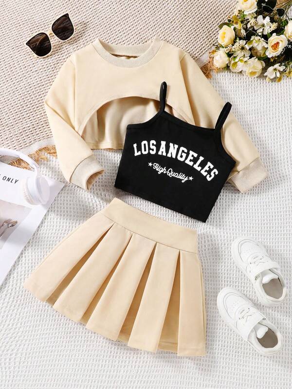 Young Girl 3-Piece Set: Apricot Sweatshirt Top, Simple Black Vest With "LOS ANGELES" Printed Letters, And Woven Skirt. The Coordinated Set In Warm, Soft Colors Provides A Comfy, Fashionable Look. Versatile For Spring, Autumn And Winter Wear.
