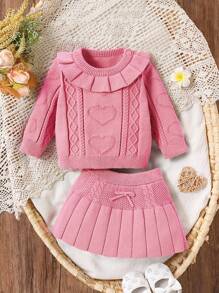 Conjunto de suéter tejido y falda plisada a juego, de moda y adorable, para niñas bebés, nueva llegada de otoño/invierno, color rosa; Falda plisada con gráfico de corazón, volantes, cinta y suéter de punto en color rosa liso, de estilo casual y dulce, adecuado para uso en casa, salidas, reuniones, Halloween, Navidad, Año Nuevo y diversas fiestas festivas. - Rosa Pálido - Ver 1