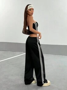 StreetHx Bộ 2 món áo bó sát hai bên hông cho nữ kèm quần thể thao rộng rãi có dây rút - màu đen - Xem 2