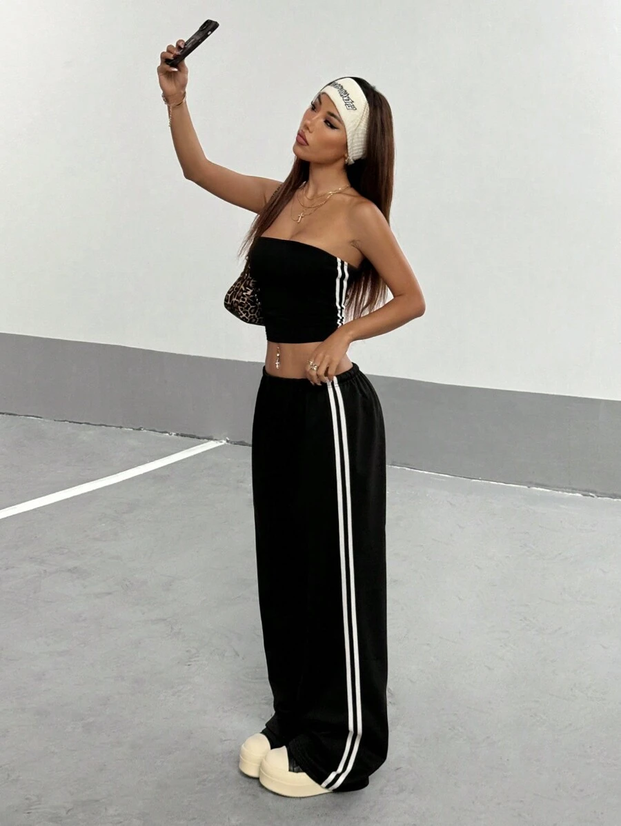 StreetHx Bộ 2 món áo bó sát hai bên hông cho nữ kèm quần thể thao rộng rãi có dây rút - màu đen - Xem 1