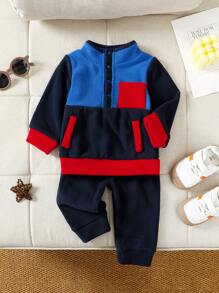 SHEIN Ensemble deux pièces à la mode et cool pour bébé garçon en hiver, comprenant un sweat-shirt tricoté multicolore avec fermeture à glissière et un pantalon de jogging noir.