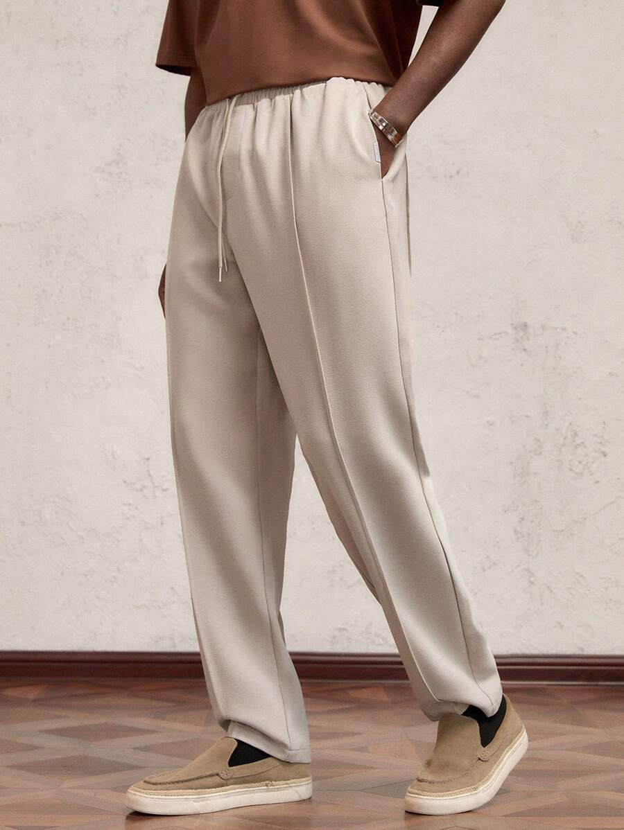 AKNOTIC Business Casual Quần dài nam dệt kim, cạp chun, ống rộng, có dây rút, màu be, thích hợp mặc hàng ngày, trang trí chữ kim loại, thiết kế phá cách. - Màu be - Xem 1