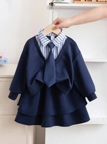 SHEIN Genkimix Kids Young Girl 2 In 1 Outfit With Shirt Collar Sweatshirt And Layered Skirt. The Blouse Features A Shirt Collar Design, Simple And Generous, Paired With A Necktie Decoration For A Playful And Elegant Look. The Skirt Adopts An A-Line Layered Design, Light And Flowy, With The Hem Swaying In The Wind As You Walk, Showcasing The Liveliness And Vibrancy