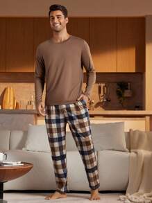 Conjunto de 2 piezas de camisa de manga larga de cuello redondo de unicolor y pantalones de pijama con estampado a cuadros para hombre, ropa de otoño