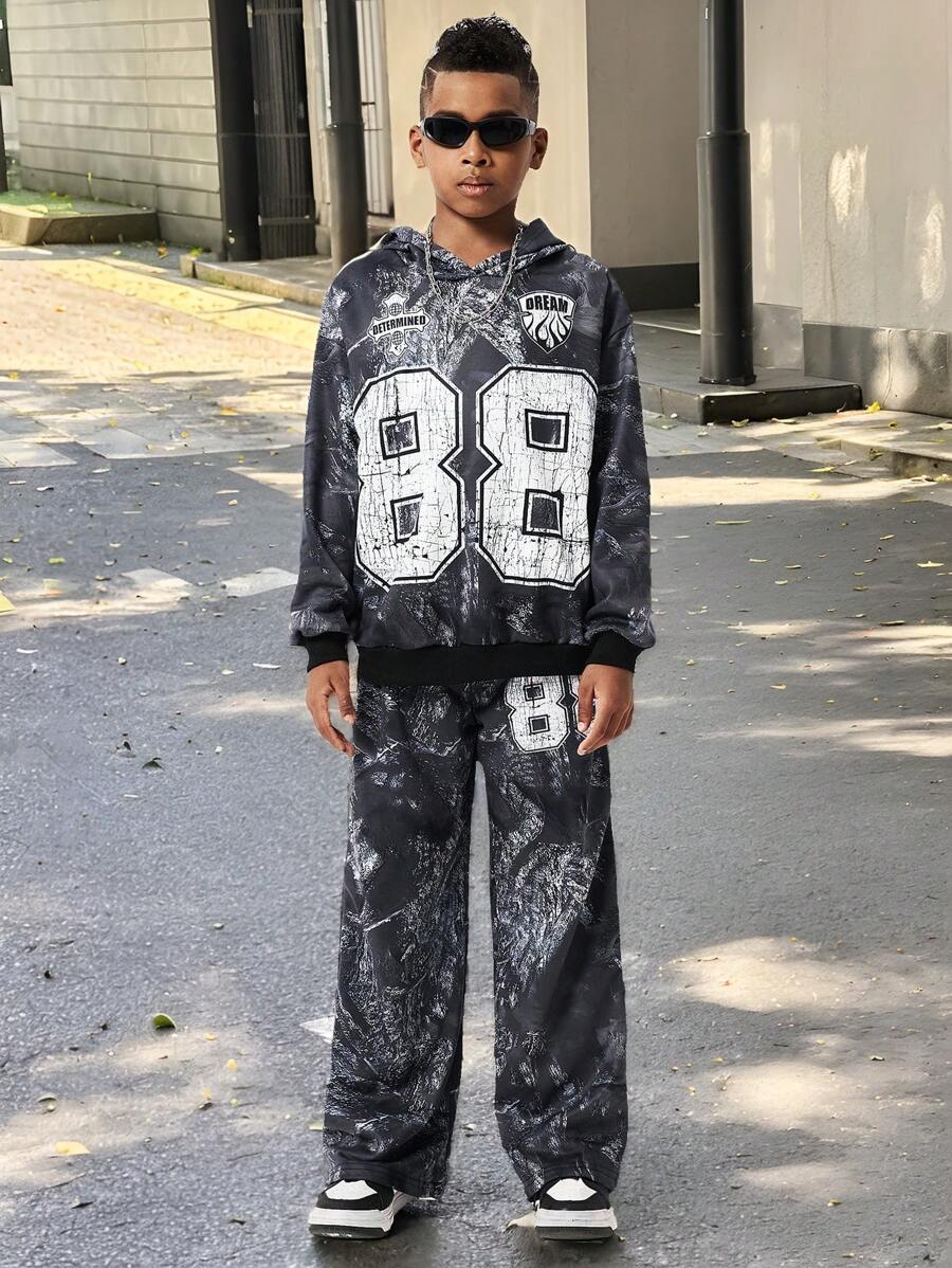 SHEIN Bộ 2 món cho bé trai tuổi teen, gồm áo hoodie và quần nỉ in hình. - màu đen - Xem 1
