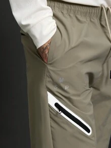 Manfinity Sport Corelite 1 pieza Pantalón deportivo informal suelto con bolsillo con cordón, estilo novio, unicolor para hombre