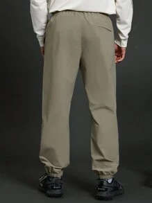 Manfinity Sport Corelite 1 pieza Pantalón deportivo informal suelto con bolsillo con cordón, estilo novio, unicolor para hombre