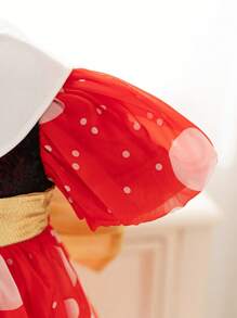 Vestido de fiesta navideña con bloques de color, lunares y lazo de purpurina dorada en tonos clásicos de Navidad