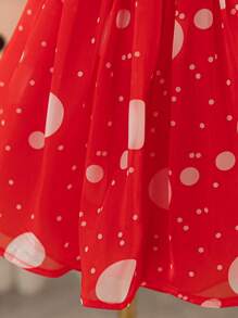 Vestido de fiesta navideña con bloques de color, lunares y lazo de purpurina dorada en tonos clásicos de Navidad