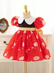 Vestido de fiesta navideña con bloques de color, lunares y lazo de purpurina dorada en tonos clásicos de Navidad