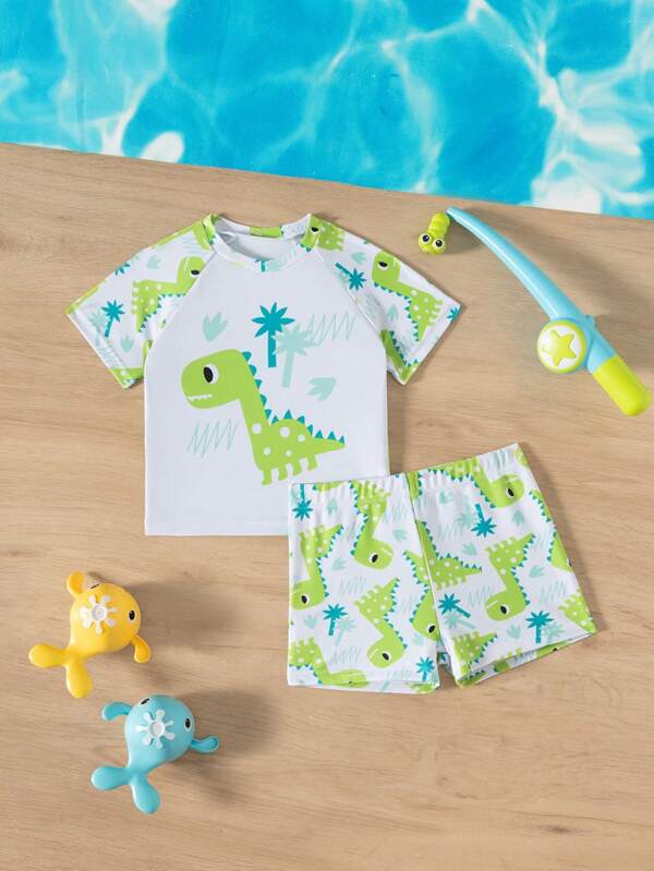 SHEIN Conjunto de 2 piezas de traje de baño para bebé niño con parte superior de manga corta y shorts con estampado de dinosaurio lindo de caricatura, adecuado para verano, playa, natación, parque acuático