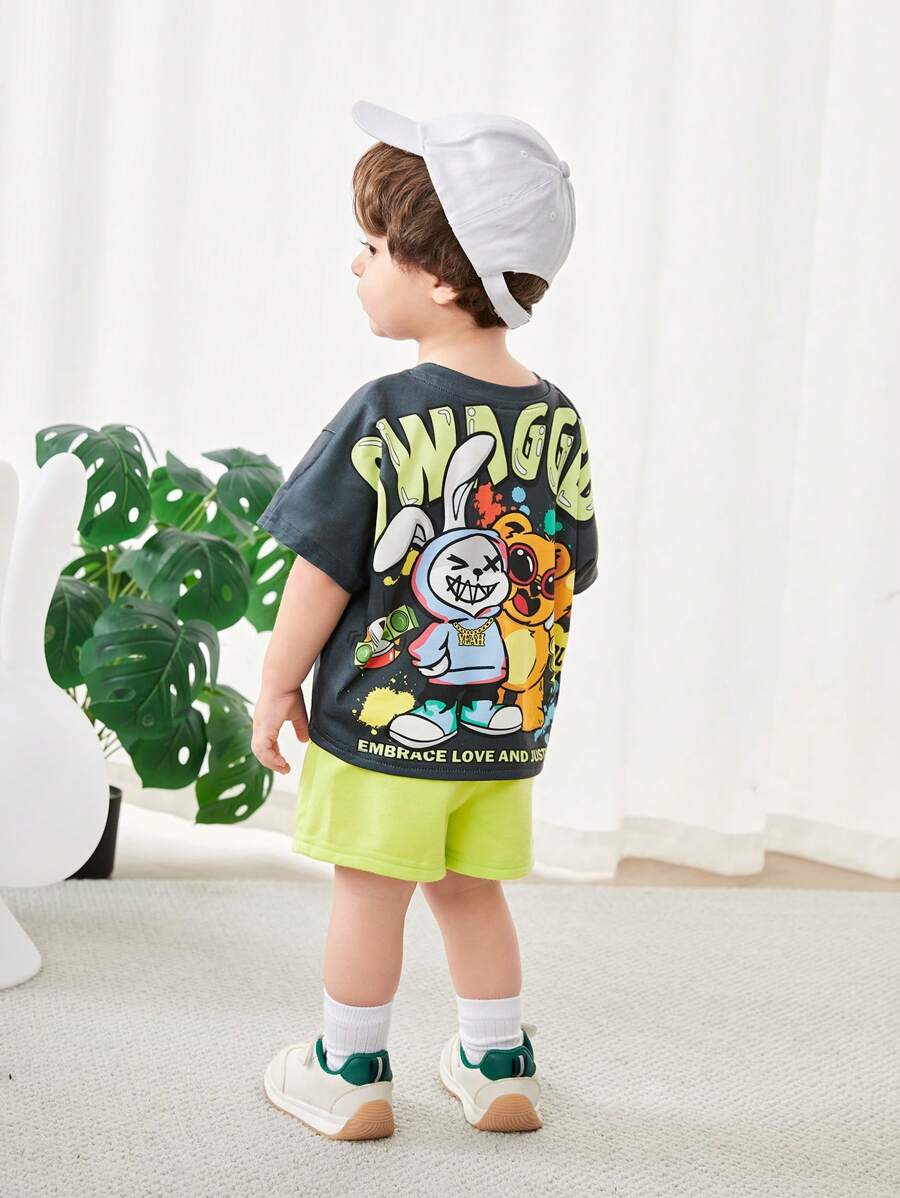 SHEIN Baby Jungen 2-teiliges Outfit: Cartoon-Tierdruck Pullover mit Dropped-Shoulder und Shorts mit Gummibund, geeignet für Lässig Sport, Zuhause, Ausflüge und Fotoshootings, Frühling/Sommer - Grün - Übersicht 1