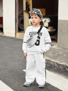 SHEIN 1 chiếc quần dài thể thao màu đen ống đứng cho bé trai, có túi tiện dụng và chất liệu vải dệt kim thoải mái, phối màu khối và chi tiết tua rua ở viền, phù hợp cho trẻ em, đi học, dự tiệc ngày lễ, lễ tốt nghiệp, mặc hàng ngày, du lịch, thể thao, mùa thu/đông. - trắng - Xem 5