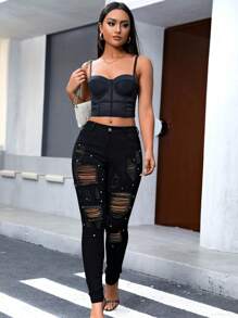 女性破洞鑲釘彈性緊身牛仔褲,具有一絲魅力和性感