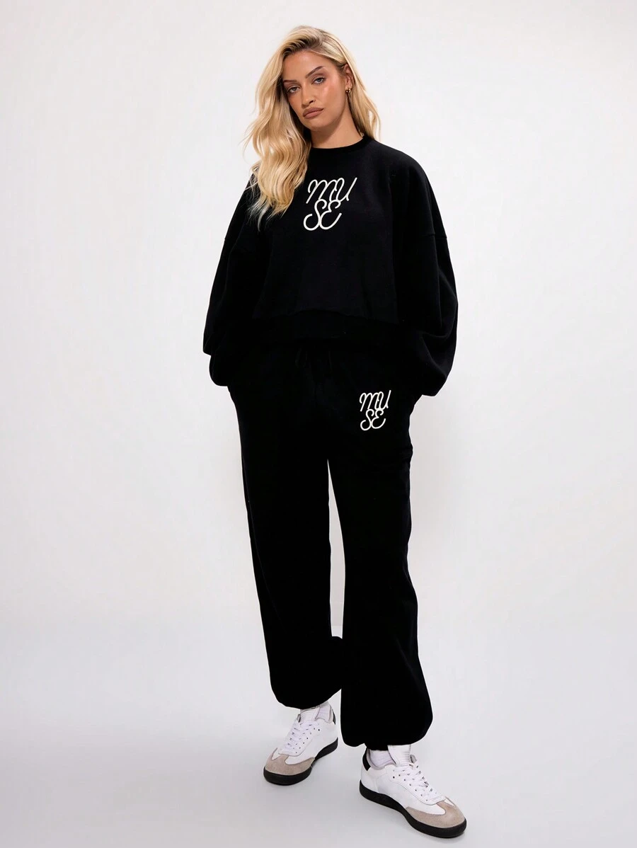 MUSERA Calça de moletom com punho e logo bordado, ideal para férias e viagens no aeroporto. - Preto - Ver 1