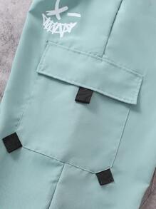 SHEIN Explorewe Spodnie casualowe dla nastolatków/młodych chłopców z nadrukiem uśmiechniętej twarzy, modne spodnie robocze