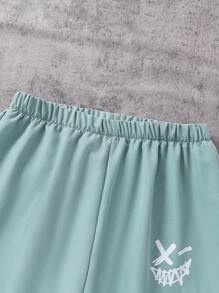 SHEIN Explorewe Spodnie casualowe dla nastolatków/młodych chłopców z nadrukiem uśmiechniętej twarzy, modne spodnie robocze