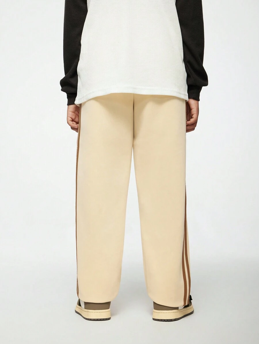 SHEIN 1 Stück lässige, gerade geschnittene Khaki Skateboard Hose für Jungen im Teenager-Alter mit braunen gewebten Streifen an der Seite, hochgeschnittenes gerades Beindesign schmeichelt der Figur und verlängert die Beine. Elastischer Bund für einfaches An- und Ausziehen, geeignet für verschiedene Anlässe wie tägliche Ausflüge, Freizeitsport oder Treffen, kann mit verschiedenen Oberteilen kombiniert werden, um deinen vielseitigen Stil und einzigartigen Charme zu zeigen.