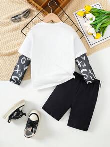 SHEIN Conjunto de ocio para niña, compuesto por top de malla con cuello redondo con estampado de graffiti de ciudad y letras en inglés, y pantalones skinny negros, estilo urbano.