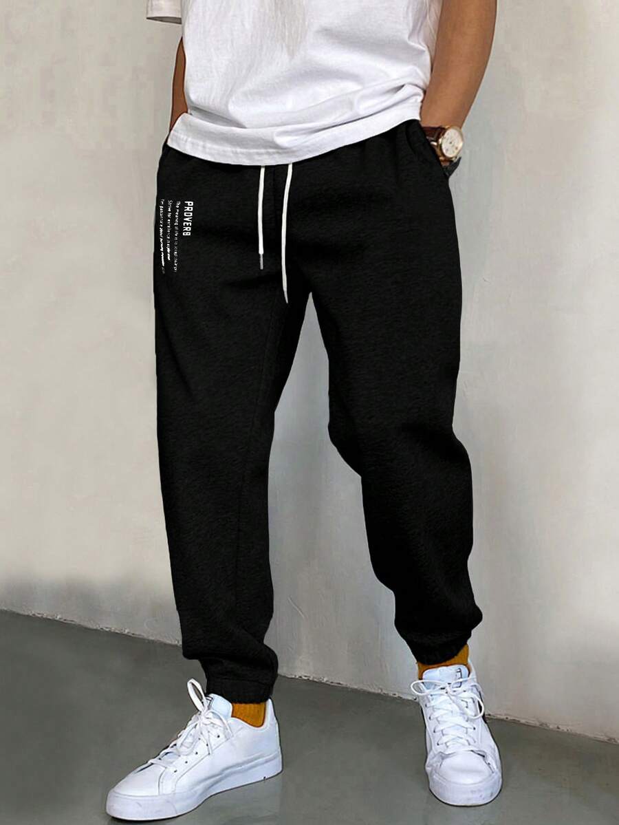 EURMUSE Bawełniane męskie spodnie dresowe ze ściągaczem w pasie i napisem graficznym - Czarne - Zobacz 1