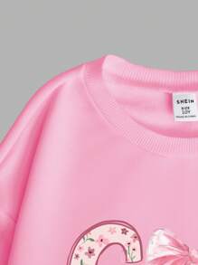Conjunto de 2 piezas para niña preadolescente que incluye sudadera con cuello redondo con estampado de arco e impresión floral "Dios es bueno" y pantalones acampanados de cintura alta con estampado de arco