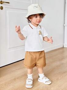 SHEIN 2pcs/Set Cute Cartoon Bear Print Lapel Short Sleeve Polo T-Shirt And Solid Color Shorts For Baby Boy And Baby Girl, Casual Outfit For Spring And Summer Indoor And Outdoor Wear - Khaki - View 1