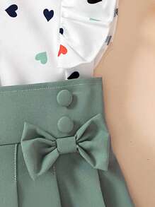 2 件套年轻女孩优雅心形印花盖袖上衣 + 蝴蝶结装饰百褶裙套装，适合夏季休闲、休闲、旅行和度假