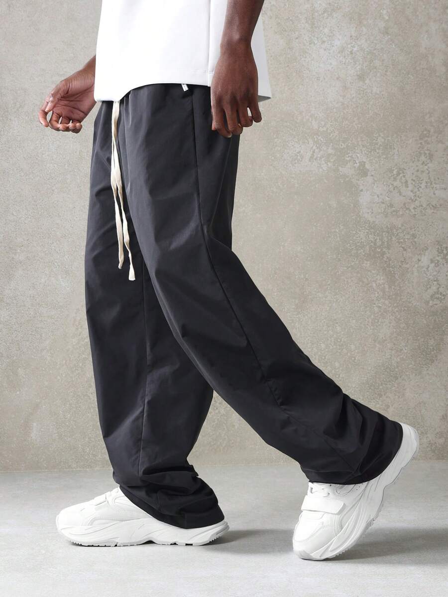 SUMWON Premium Nylon Wide Leg Pleated Pants Relaxed Fit Drawstring Athletic Urban Streetwear Casual Trousers All-Season Comfort Performance Bottoms - Black - View 1