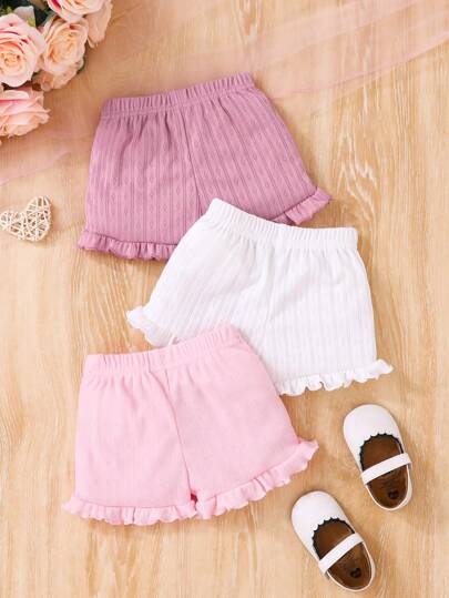 SHEIN Set de 3 piezas de pantalones cortos informales y cómodos para niña bebé, de cintura elástica, de tela de punto calada con estampado floral y dobladillo con volantes, en unicolor rosa y blanco, con múltiples opciones, alta relación calidad-precio, adecuado para uso casual y vacaciones en primavera/verano