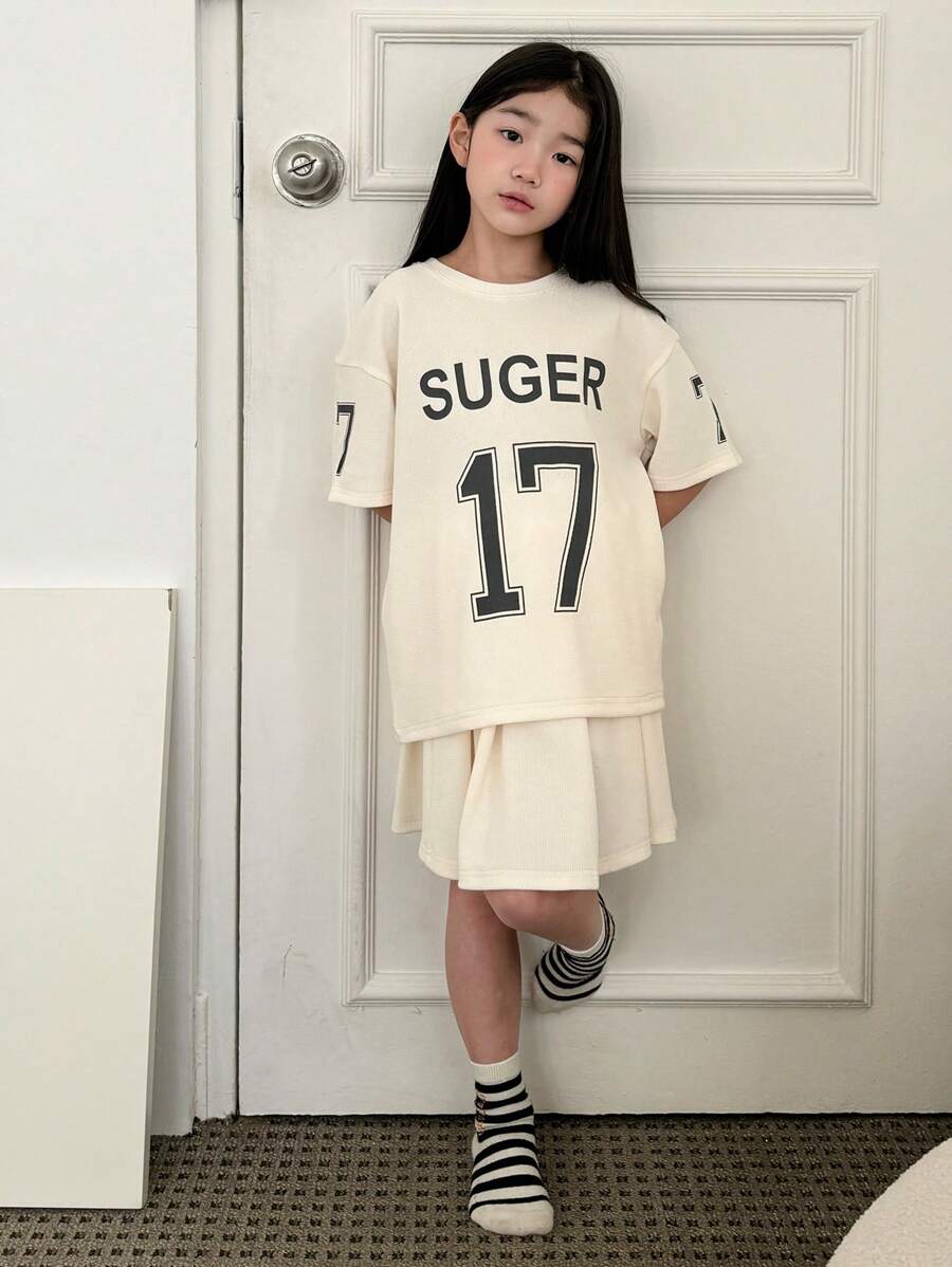 Dazy Kids Set de 2 piezas para niña preadolescente que incluye blusa de manga corta con cuello redondo y estampado de letras, y falda informal. Conjunto de ropa de verano para niñas, ideal para volver al colegio. - Albaricoque - Ver 1