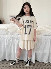 Dazy Kids Set de 2 piezas para niña preadolescente que incluye blusa de manga corta con cuello redondo y estampado de letras, y falda informal. Conjunto de ropa de verano para niñas, ideal para volver al colegio. - Albaricoque - Ver 2