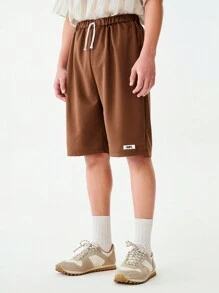 SHEIN 1pc Teen Boys Solid Brown Simple Casual Loose Shorts, With Brand "UNPL" Print On Left Leg, Drawstring Waist Design, Relaxed Fit Suitable For Sports Shoes And Outdoor Activities, Sporty & Casual Occasions - Brown - View 6
