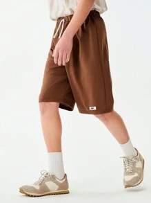 SHEIN 1pc Teen Boys Solid Brown Simple Casual Loose Shorts, With Brand "UNPL" Print On Left Leg, Drawstring Waist Design, Relaxed Fit Suitable For Sports Shoes And Outdoor Activities, Sporty & Casual Occasions - Brown - View 1