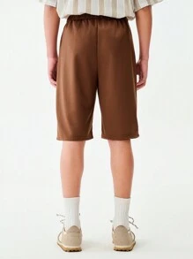 SHEIN 1pc Teen Boys Solid Brown Simple Casual Loose Shorts, With Brand "UNPL" Print On Left Leg, Drawstring Waist Design, Relaxed Fit Suitable For Sports Shoes And Outdoor Activities, Sporty & Casual Occasions - Brown - View 2