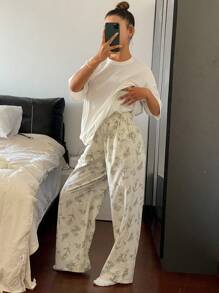 Livesso Conjunto de pijama con top de camiseta holgada de unicolor y pantalones estampados con dibujos florales de líneas en todo el diseño